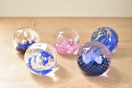 A Caithness Fiesta glass paperweight, h7cm, sold together with 4 others