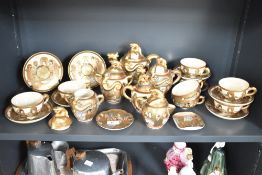 A Japanese tea service decorated with figures on a gold ground, to include tea pots, coffee pots,