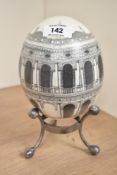An ostrich style egg decorated with a 360 degree architectural persective, 14.5cm
