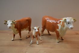A Beswick Pottery Hereford Cattle trio comprising Hereford Bull model number 949, Hereford Cow model