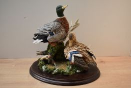 A Country Artists animal group 'Restful Days' model number CA802, on wooden plinth measuring 30cm