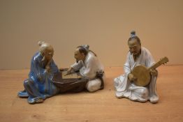 Two 20th Century Chinese Mudmen figures depicting a banjo player and the other a game of checkers.