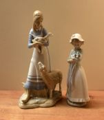 A Nao by Lladro porcelain figurine 'Girl holding dog' sold together with a similar continental