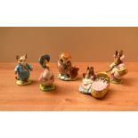 A group of five Beswick Pottery Beatrix Potter characters including 'Tom Kitten' crack to base, '