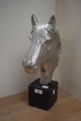 A large cast aluminium sculptural horse head, raised on square base with damage to front of the