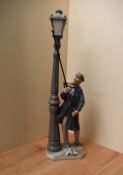 A Lladro porcelain figure 'The Lamp Lighter' model number 5205, damages to hand with previous