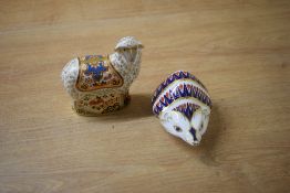 A pair of Royal Crown Derby bone china paperweights comprising a Crown Derby visitors centre