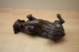 A heavy resin Daschund study depicted laid on it's back, having signature to reserve, damaged.