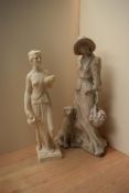 Two large resin figurines depicting a female water carrier and a female with dog and picnic