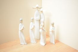 A group of five Lladro and similar porcelain figures/figurines including 'Boy Kissing' model