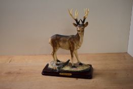 A large resin study of a Buck Deer, on plinth, measuring 30cm tall complete with box. Damage to