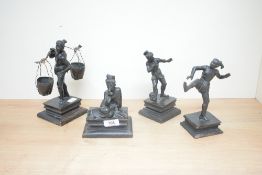 A group of four bronze mudmen style figures, all on wooden bases.