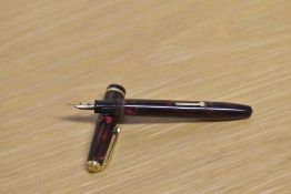 A Conway Stewart Dinkie 560 lever fill fountain pen in Maroon and Gold Marble with a single cap band