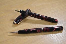 A Parker Duofold Junior button fill fountain pen and Propelling pencil in Burgundy and Black