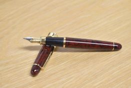 A Fabio Zanni cartridge fill fountain pen in red having irdium nib. Some deterioration to trim abobe