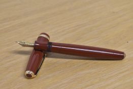 A Parker Duofold button fill fountain pen in Terracotta with wide decorative cap band having