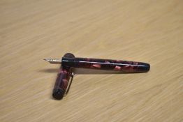 A Parker Duofold button fill fountain pen in Burgundy and Rose marble with two narrow cap bands