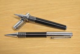 A boxed black and chrome ballpoint and rollerball pen set