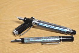 A boxed Kingsley converter fill fountain pen and ballpoint pen in Aqua Blue swirl with Black cap