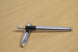 A Cross Townsend Medalist converter fill fountain pen in stainless steel with gold trim having M