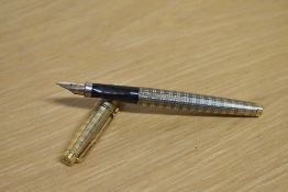 A Parker 75 converter fill fountain pen in Gold plated Ecosse pattern having Parker 14K USA nib