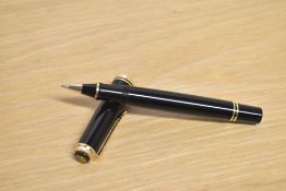 A boxed Pelikan Souveran rollerball in Black and Gold trim