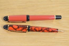 A Waterman Phileas rollerball pen in Red and Black with gold trim and a Waterman Phileas ballpoint
