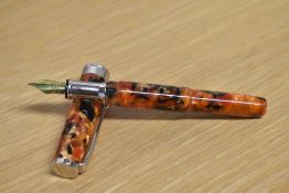 A boxed Sigma converter fill fountain pen in Red, Black and Yellow Marble having Iridium Point