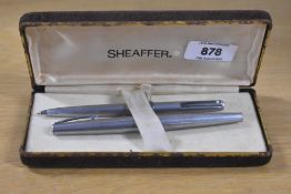 A boxed Lady Sheaffer 620 fountain pen in brushed steel with a florentine band having Sheaffer nib