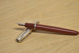 A Parker VP button fill fountain pen in Rust with a Rolled Gold cap having a Parker USA nib