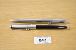 A Parker 45 ballpoint pen in stainless steel sold with a Parker 45 ballpoint pen in black (