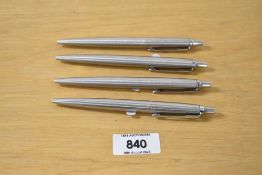 Four Parker Jotter ballpoint pens in stainless steel