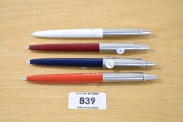 Four 1980's Parker Jotter ballpoint pens in burgundy, blue, white and orange marked Oriana)