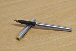 A Parker Arrow aerometric fountain pen in brushed steel with gold trim.