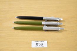 Three 1970's Parker Jotter ballpoint pens two in olive green the other in black with a window panel