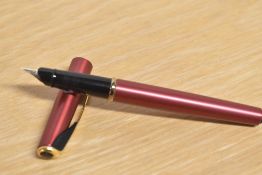 A Parker Inflection converter fill fountain pen in Sunny Red