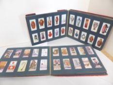 COLLECTION OF CIGARETTE CARDS IN 2 ALBUMS INCLUDING OGDENS ETC LARGELY BY SET Clean collection to
