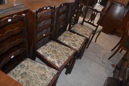 A set of four oak ladder-back chairs with drop in seats and turned supports