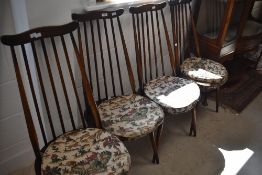 A set of four Dark elm Ercol high spindle back chairs