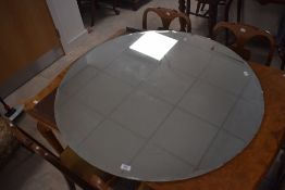 A large vintage circular mirror plate with bevelled edge detail 100cm