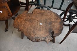 A 20th century transverse wood section coffee table raised on a trestle style base, L68cm x h38cm