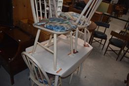 An Ercol 'style' white wash drop leaf table, h74cm x w93cm x d64cm, sold together with four chairs