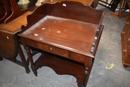 A Victorian design mahogany washstand with shaped three quarter gallery, single frieze drawer and
