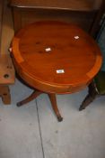 A small reproduction yewood circular drum occasional table with pedestal support 60cm