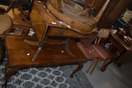 A reproduction mahogany coffee table of oblong form with moulded edge detail, sold along with a