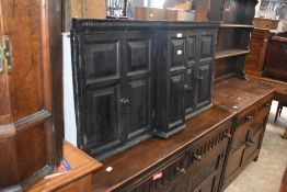An unusual George III oak wall cupboard, of break-front form with dentil moulded frieze and double
