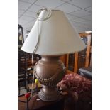 A modern table lamp having vase style base