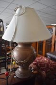 A modern table lamp having vase style base