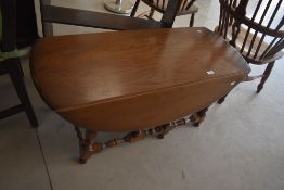 An Ercol 'Golden Dawn' drop-leaf coffee table having elm wood top and beech legs, 'model 506',