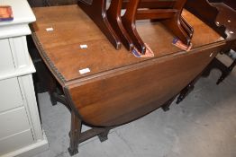 An early - mid 20th century oak drop leaf table with moulded detail to edge and legs 76cm x 103cm